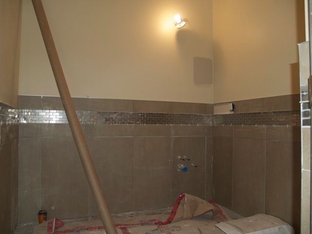 tile work continues in bathrooms