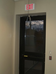 glass in outside door - exit button visible to right