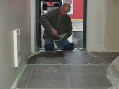 finishing the floor tile at staff entrance